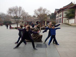 Our kids having fun with the statues in the park