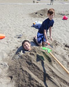 Noah learning what it means to have siblings and Toby loving it - they took turns burying each other all afternoon.