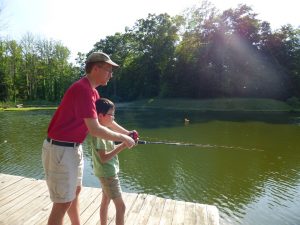 Noah trying fishing for the first time at Doctor Dan and Stevie's lake