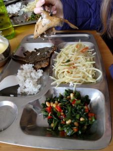 Our lunch at the orphanage - whole fish, rice, congee, shredded spicy potato, greens, and steamed buns.